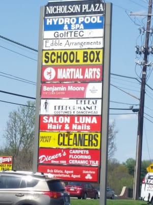 Sign for the strip mall, new Kensington location. ( is the P.O. listed?) U can see Wendys sign.