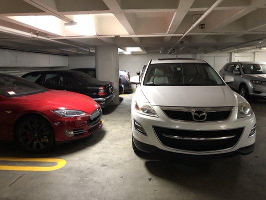 My car blocked in by this white SUV (parked there by the lot's valet service).