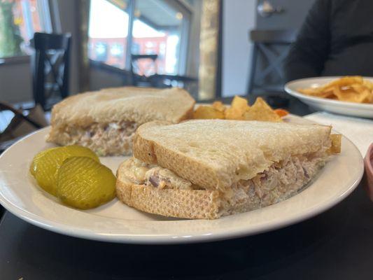 Fresh crab sander with a side of chips and drink