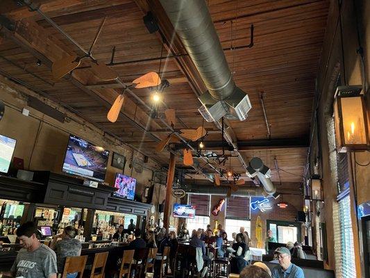 Huge bar area with booths, pub tables, hang out space, and counter seats