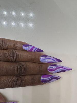 Purple stiletto nails.