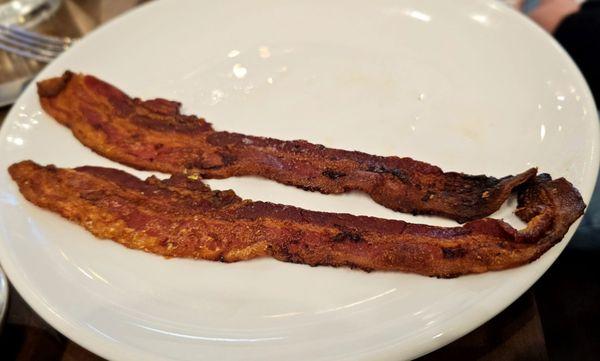 Side of bacon minus one eaten slice