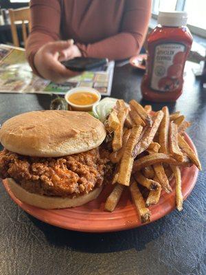 The mother cluckin sandwich fries with nacho cheese on the side and a grilled jalapeño