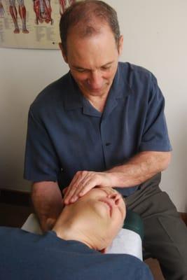 Dr. Steve performing massage prior to adjustment of person in an auto accident.