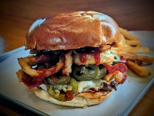 Rodeo - Smash patty, BBQ sauce, onion rings, pickled jalapenos, American cheese, griddled brioche bun.