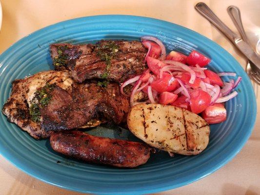 Mixed Grill of Chicken, Pork and Beef with Tomatoes Red Onions and grilled half potato