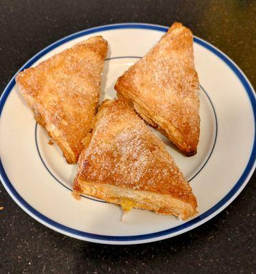 Turnovers with apple, strawberry and pineapple filling. Flakey and delicious! Hot from the oven.