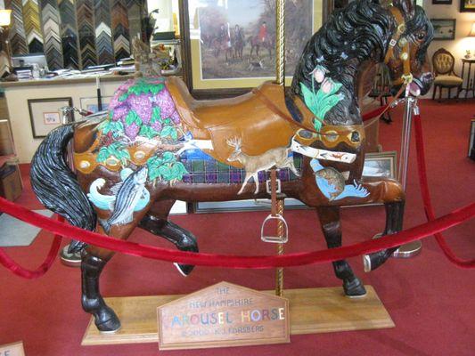 Local artist designed and maNde this New Hampshire Carousel Horse. [Note NH symbols]