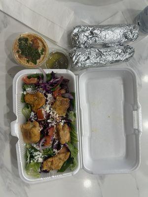 Greek salad with chicken and a side of hummus with bread