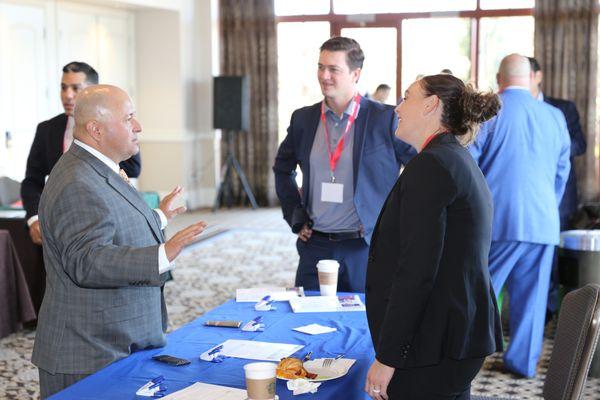 Sal Mendoza, Vice President of Field Support, conversing with insurance carrier representatives at LifePro University.