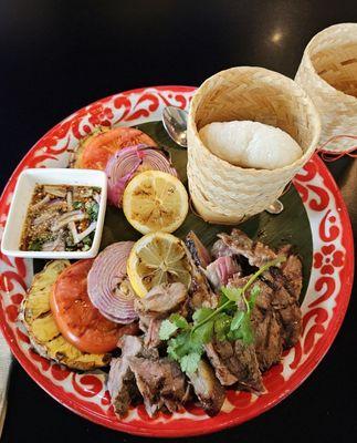 Suer Long Haj, marinated steak, sticky in the basket, tamarind dipping sauce, grilled red onion, tomatoes & pineapple