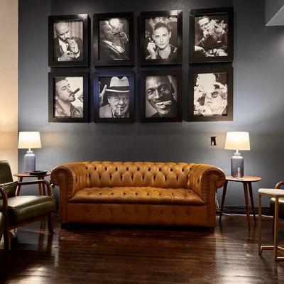 Stories Churchill Member lounge space with Chesterfield couch and famous smoking wall.