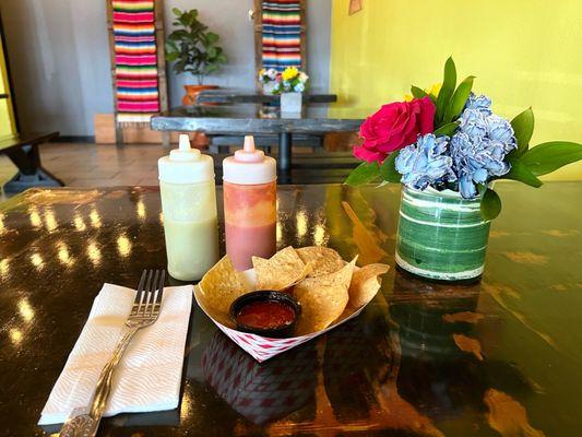 Chips and salsa for dining in & sauces. Real fork! Fresh flowers on each table!