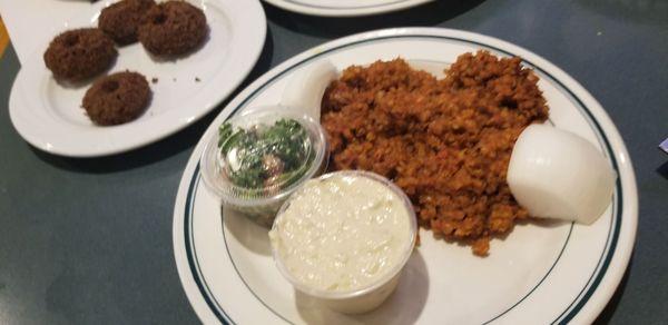 Sleek, baba ghanoush, tabouli, and falafel