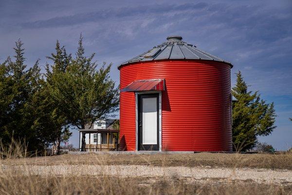 Grain silo conversion under the big Texas sky definitely belongs in this landscape!