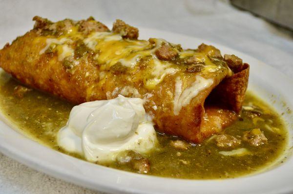 Chimichanga smothered side of sour cream.