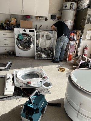 Victor deeply involved in replacing a part in my dryer.