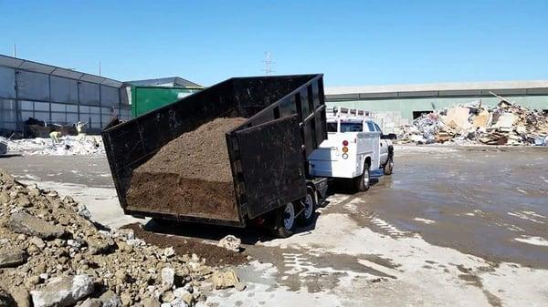 Dumping dirt we dug up from a back yard.