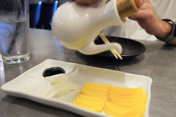 Banchan (free side dishes) pickled daikon, onions, and black bean sauce