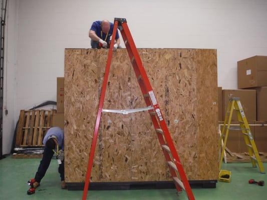 Finishing a crate for an assembly robot for international shipment.