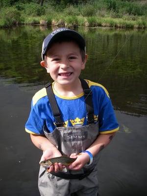 Kids love fishing. Gabriel with his first brook trout at age 7. Photo by Jim Cannon