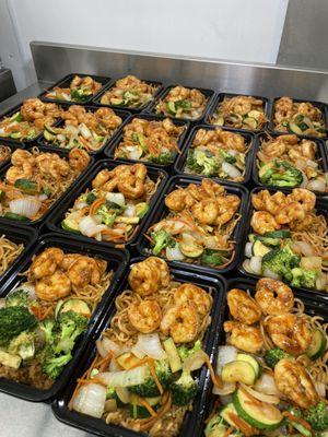 Garlic butter shrimp with noodles, fried rice and veggies