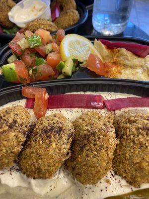 Baba ghanoush platter with falafel, Syrian salad, and hummus