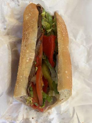 Toasted roasted beef with peppers, lettuce, tomatoes, delicious