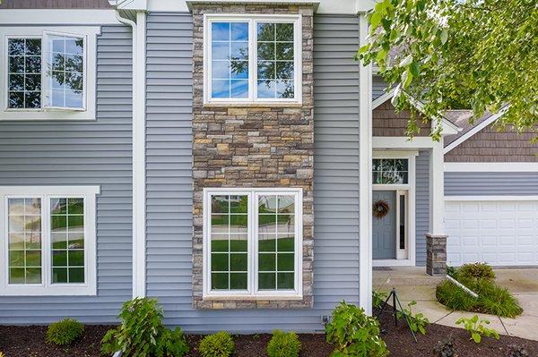 Vinyl lap, stone veneer and composite shake siding all compliment each other and are proof that sometimes more is more!