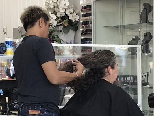 Girlfriend getting her dreadlocks handled.