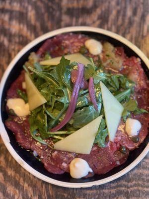 Filet Mignon Carpaccio: Brenton salt, lime pith, Meyer Lemon, olive oil, topped with Arugula, Beaufort ribbon, pickled onion, capers.