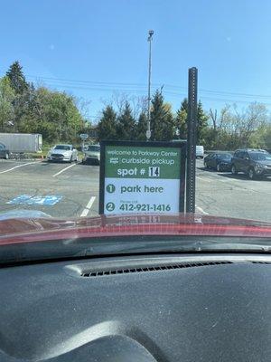 Pull in, call that number and tell them what number parking space you're at!