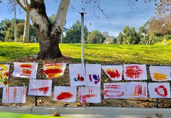 There's a theme each month that gets reflected in the childrens' artwork. For transportation month, they painted with cars!