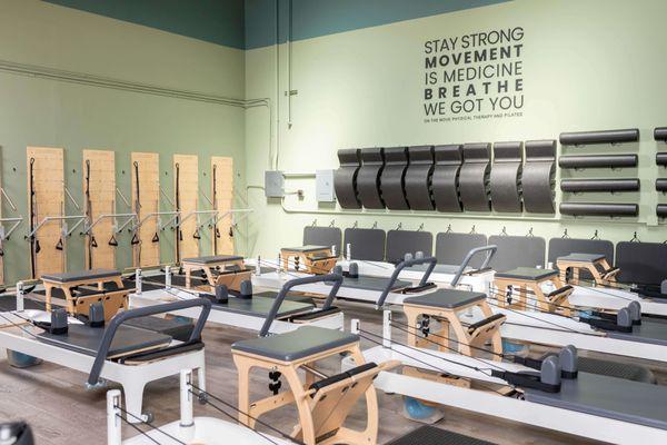 Small Pilates studio in Belmont, CA. Reformers, pilates chairs, and springboard.