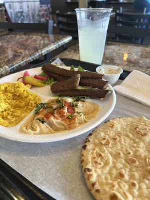 Gyro plate with rice pilaf and hummus.