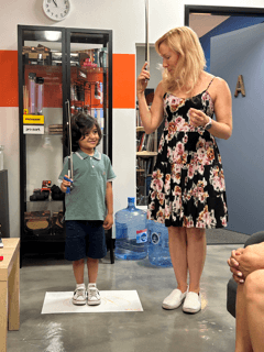 Instructor Hillary works with a young Violin student