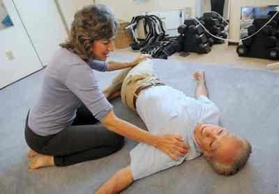 Dot does a back pain relieving move with pianist John Boyajy on July 2, 2013. (Alan Dep/Marin Independent Journal)