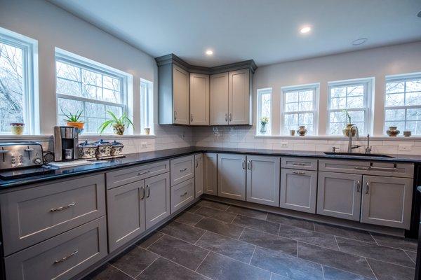 Gray modern cabinet with black countertop. design and installed by Tile Center