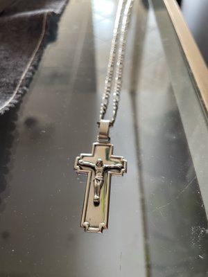 A picture of a cleaned cross necklace