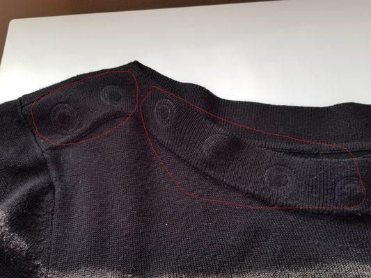 AFTER: Picture of sweater after it was picked up from dry cleaner.  Showing decorative rings missing and imprints left around the neckline