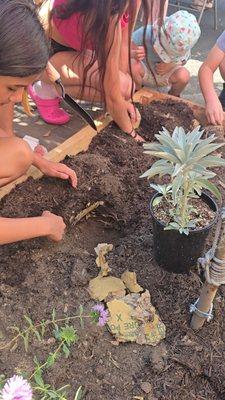 Helping hands in our centers garden.