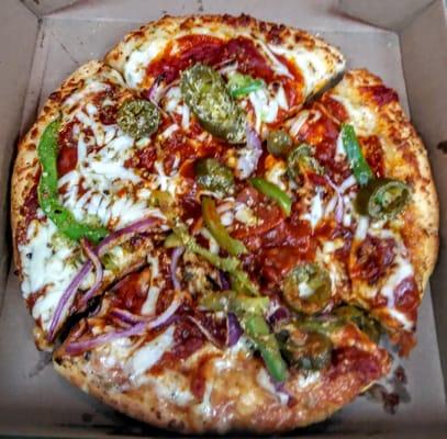 Subway personal pizza with pepperoni, green peppers, onions, tomato, jalapenos.