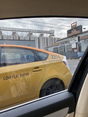 His cab number with complaint hotline reflected in window