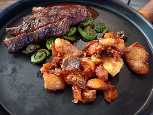 Wagu Skirt Steak, papa's bravas,grilled ramps,fiddlehead ferns,Madeira reduction