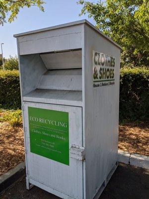 Used clothes drop-off box at the front entry to the parking lot