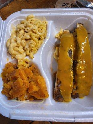 2 meaty ribs with gold sauce, a good choice, yams, and mac-n-cheese