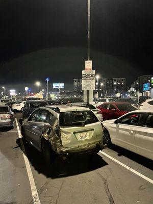 Wrecked car has sat for two weeks in Planet Fitness lot.