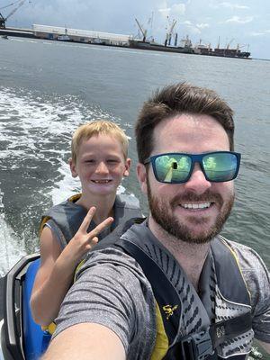 Justin w/Logan cruising on a jetski at Panama City Beach.