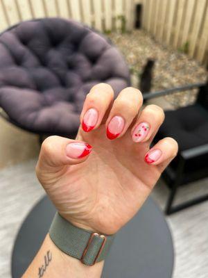 Manicured French-tip nails with cherry design