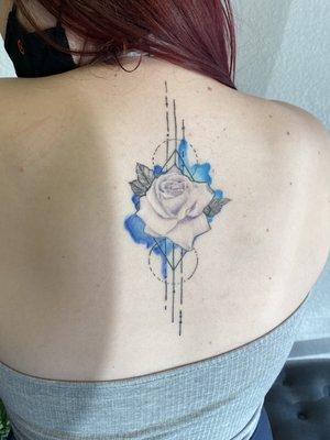 Rose tattoo with watercolor done by arrow Nicole